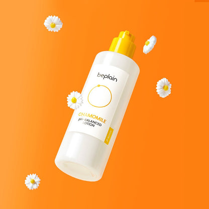 beplain Chamomile pH-Balanced Lotion 150ml bottle with yellow pump surrounded by chamomile flowers on orange background