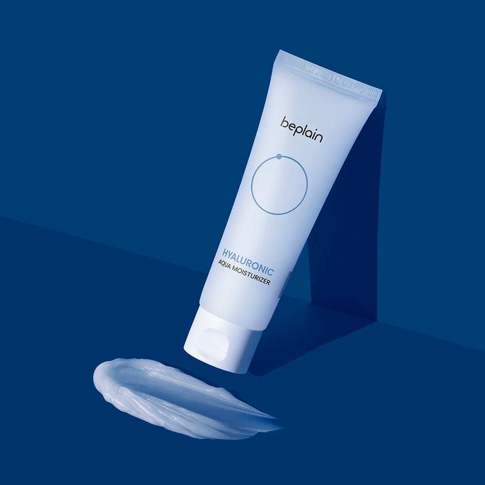beplain Hyaluronic Aqua Moisturizer 80ml tube with creamy texture on deep blue background for instant hydration benefits