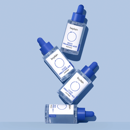 beplain Multi Hyaluronic Acid Ampoule 30ml bottles with blue droppers arranged on soft blue background for deep hydration benefits