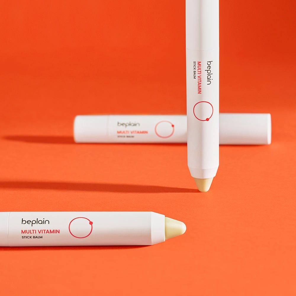 beplain Multi Vitamin Stick Balm 2.9g in sleek white stick with brightening effect on vibrant orange background