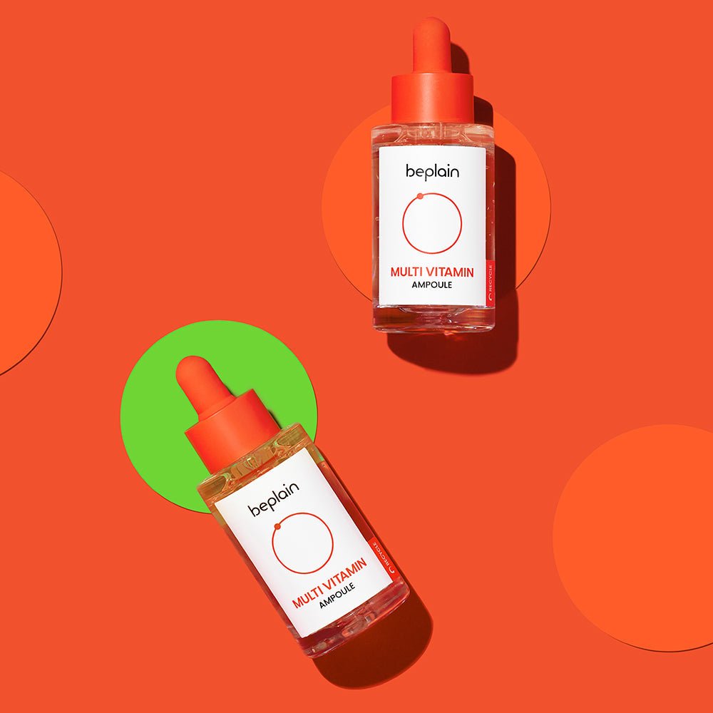 beplain Multi-Vitamin Ampoule 30ml in clear bottles with orange caps on vivid orange background for revitalizing skin benefits