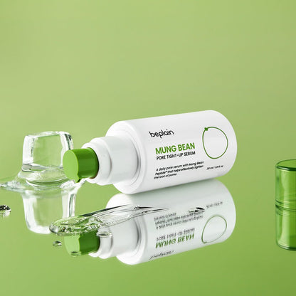 beplain Mung Bean Pore Tight-up Serum 30ml in white bottle with green cap and clear serum on reflective green surface