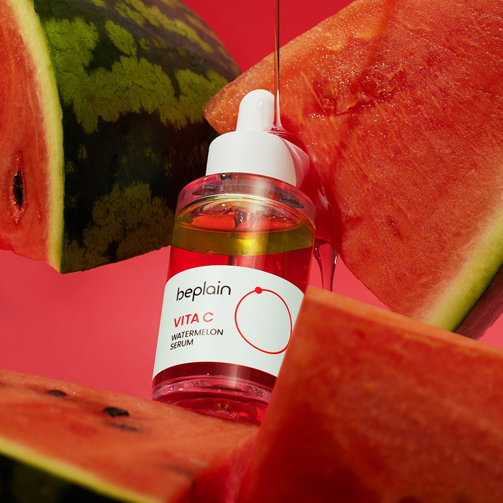 beplain Vita C Watermelon Serum 30ml bottle with dropper surrounded by fresh watermelon slices on red background