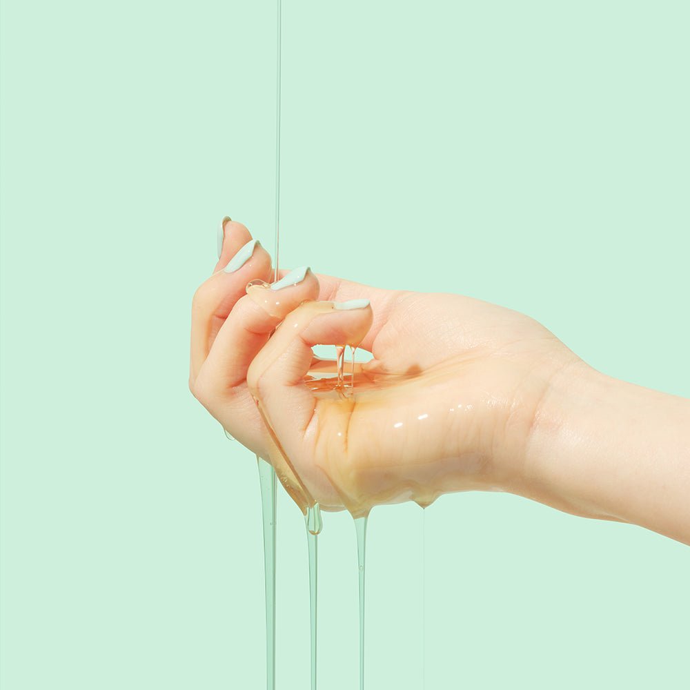 beplain Cicaterol Ampoule 30ml soothing serum texture dripping down hand against pale mint background