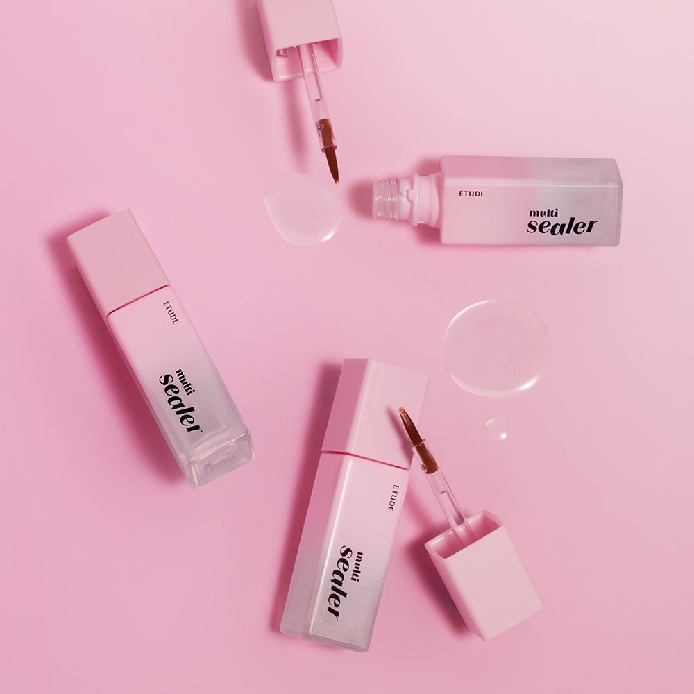Three ETUDE Bare Edge Makeup Multi Sealer 8g bottles with applicators and clear product drops on pink surface