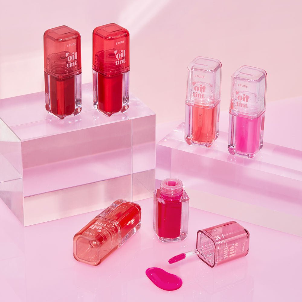 ETUDE Dear Darling Oil Tint 4.2g in vibrant pink and red shades with long-lasting color displayed on clear blocks
