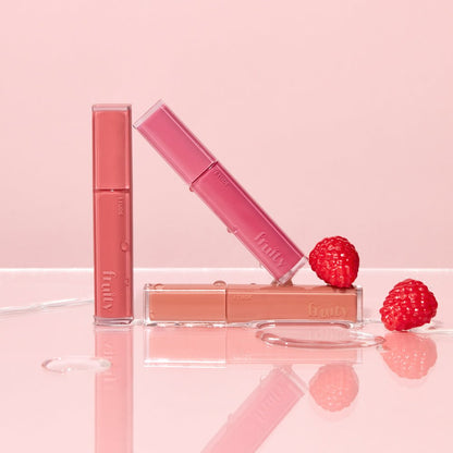 ETUDE Fruity Dewy Tint 4.5g tubes in pink, coral, and peach shades with fresh raspberries on glossy surface