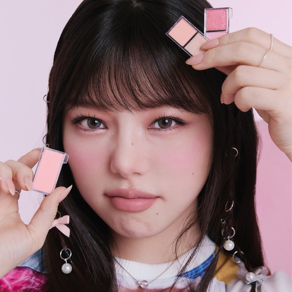 Young woman with soft makeup holding ETUDE My Best Tone Eye 2-Color Refill eyeshadow shades near her face