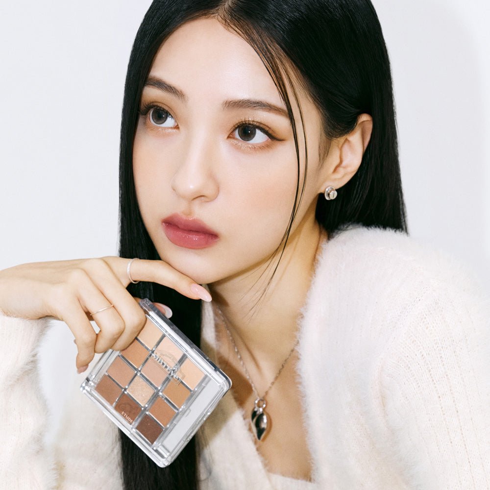 Model with natural makeup holding ETUDE My Best Tone Eye Palette featuring diverse texture eyeshadow shades
