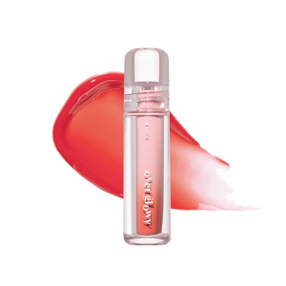 ETUDE Over Glowy Tint 3g in clear tube with high gloss formula and peachy coral gloss smear background