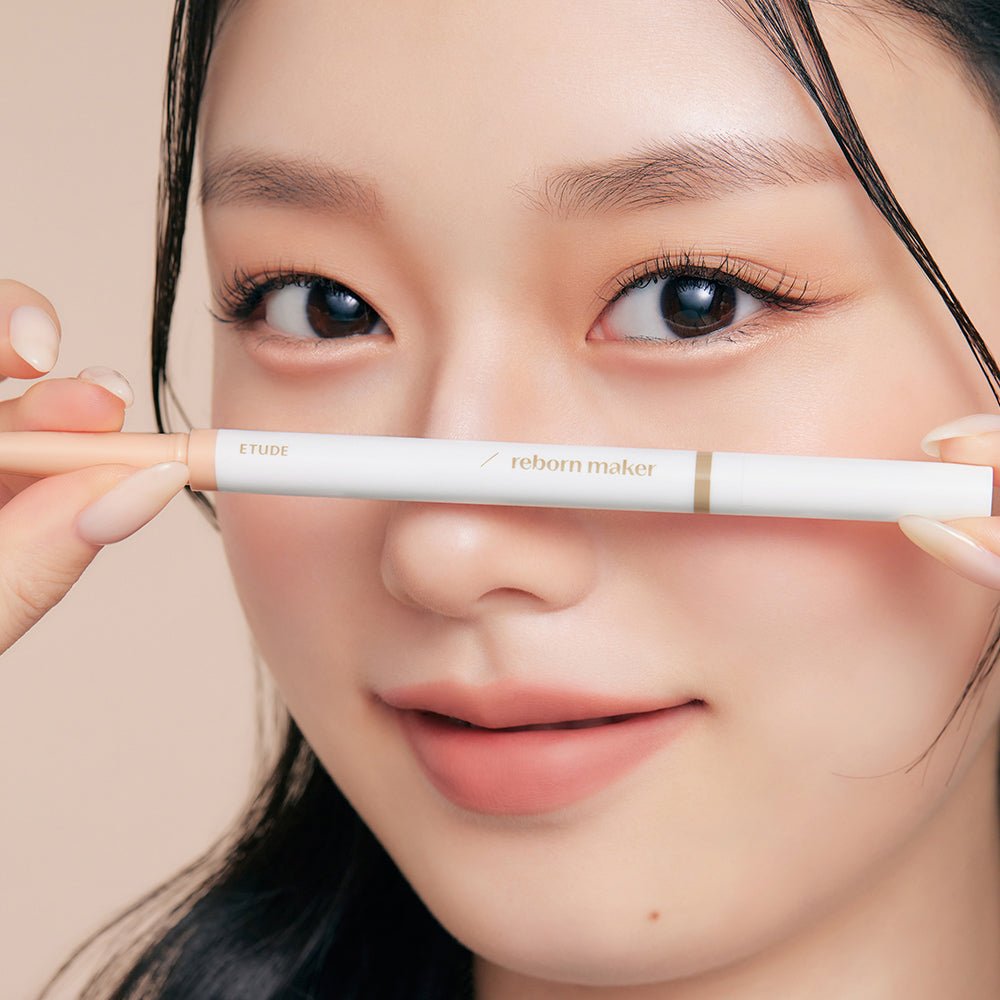 ETUDE Reborn Maker Liner 0.9g held close to face highlighting double-tip design for precise eye definition.