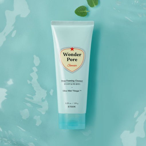 ETUDE Wonder Pore Deep Foaming Cleanser 150g tube on blue surface with mint leaves for deep cleansing