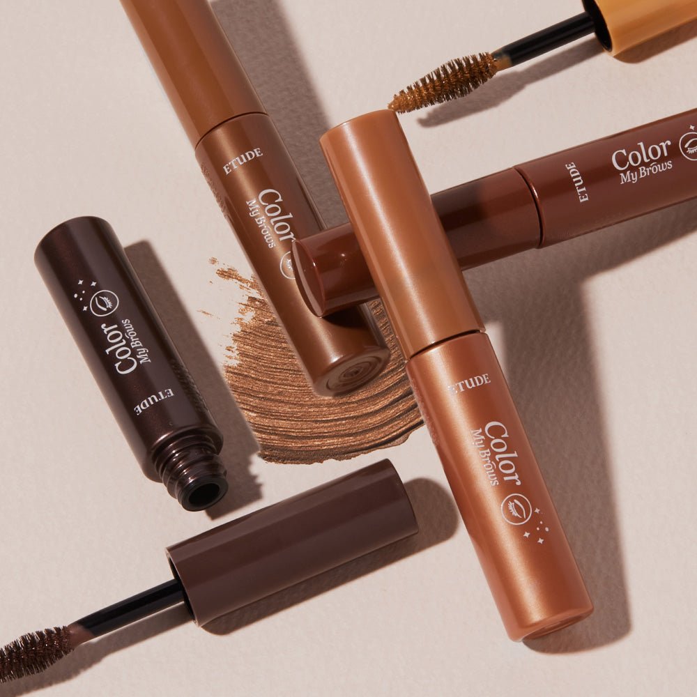 ETUDE Color My Brows 4.5g tubes with natural color brow tint and applicator brushes on beige background
