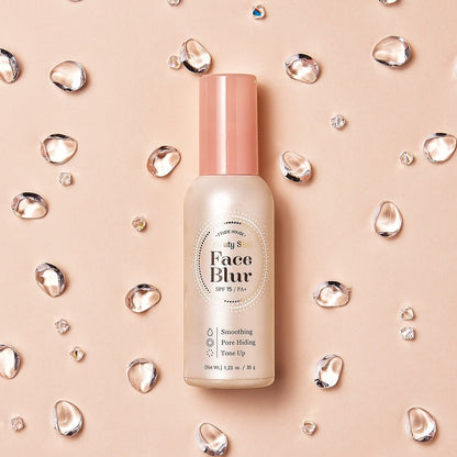 ETUDE Face Blur SPF 33 PA++ 35g in frosted bottle with pink cap surrounded by clear water droplets on beige background