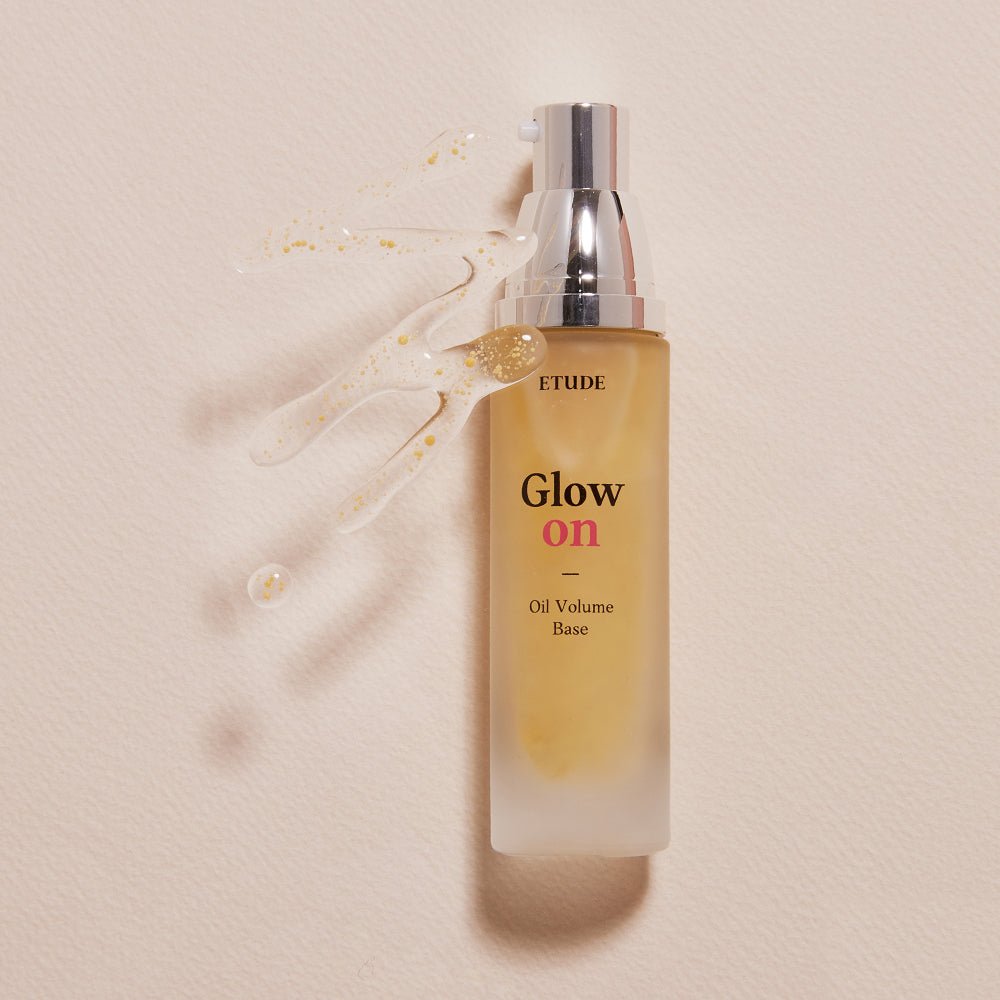 ETUDE Glow On Base Oil Volume 30ml bottle with pump and moisture-boosting formula on beige background