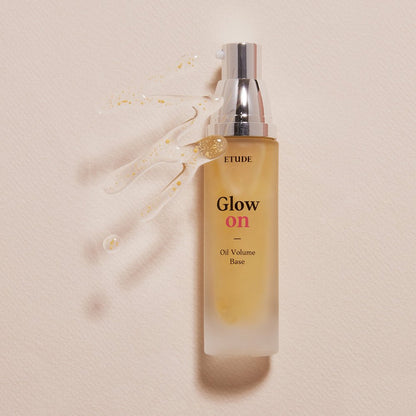 ETUDE Glow On Base Oil Volume 30ml bottle with pump and moisture-boosting formula on beige background