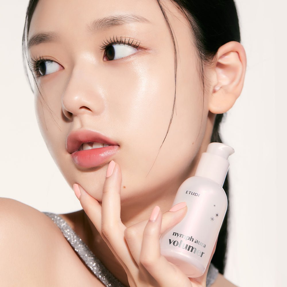 ETUDE Nymph Aura Volumer 24g held by woman with radiant glowing skin emphasizing luminous complexion