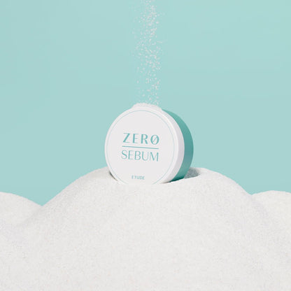 ETUDE Zero Sebum Drying Powder 4g container surrounded by fine white powder representing oil control benefits