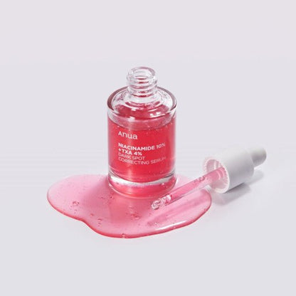 Anua Niacinamide 10% + TXA 4% Dark Spot Serum 30ml with brightening, hydrating benefits shown with dropper and spilled serum
