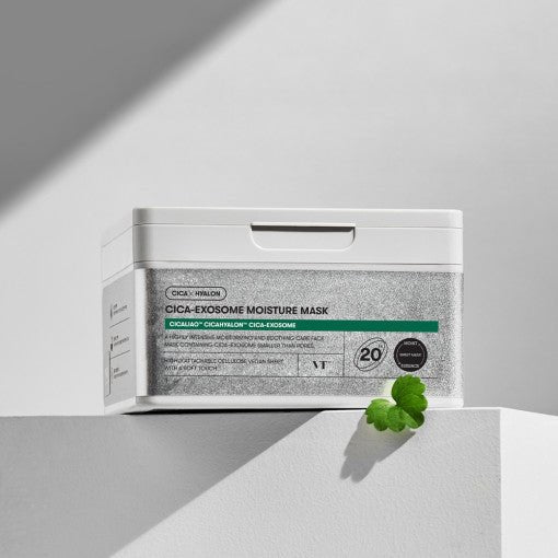 White container of VT Cica-Exosome Moisture Mask 350g 20ea with green leaf and soft natural lighting