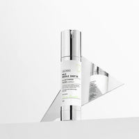 VT Mild Reedle Shot 50 50ml in white and silver bottle with pump dispenser enhanced for better absorption displayed with reflective surface