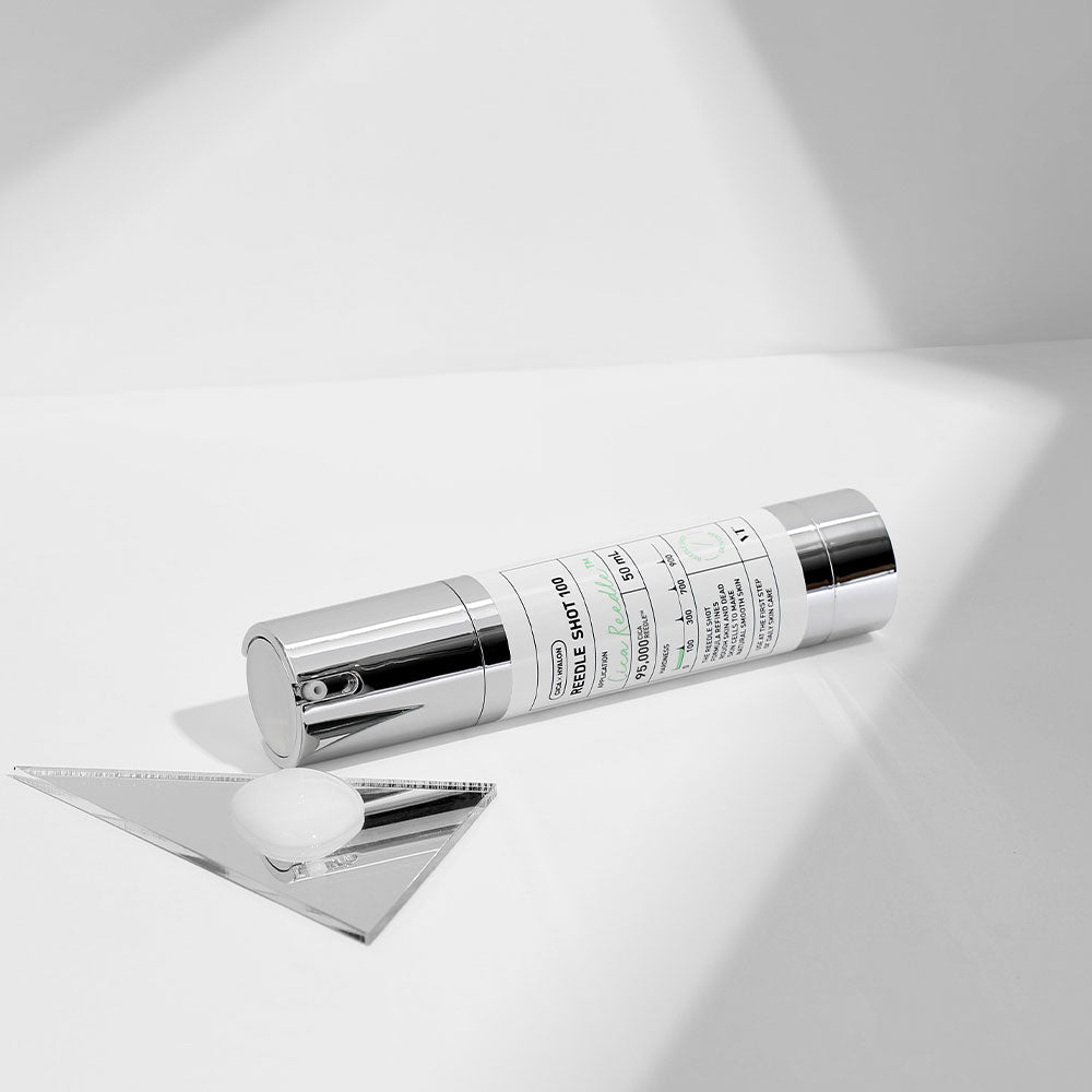 VT Reedle Shot 100 50ml in silver pump bottle with deep nourishment benefits placed on white surface with triangular mirror piece