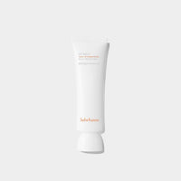 Minimalist white tube of broad spectrum sunscreen with subtle orange text on a plain light background