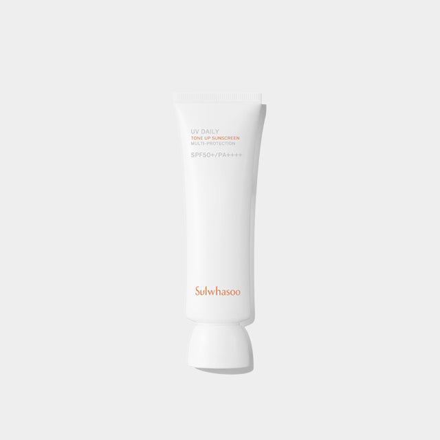Minimalist white tube of broad spectrum sunscreen with subtle orange text on a plain light background