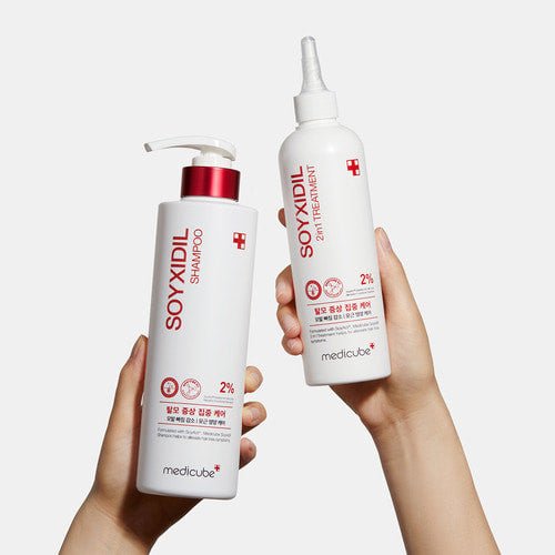medicube Soyxidil Shampoo 490ml pump bottle held with matching treatment bottle for hair loss prevention care
