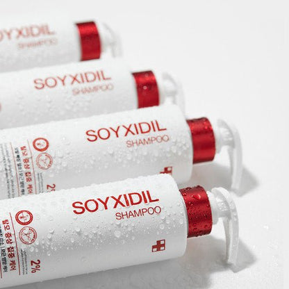 medicube Soyxidil Shampoo 490ml in white bottles with red pump caps arranged diagonally with water droplets