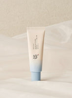 Minimalist tube with soft blue cap containing hydrating sun protection cream on neutral fabric background