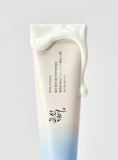 Tube of hydrating sun protection with creamy white sunscreen texture dripping down in soft gradient packaging