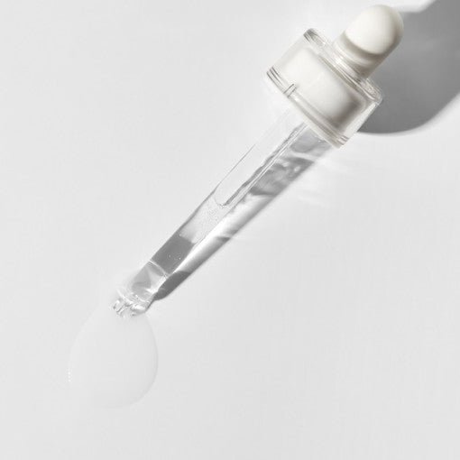 Clear glass dropper releasing hydrating serum with smooth, lightweight texture on white surface background