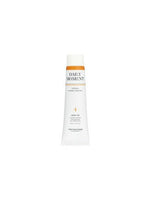 Slim white tube of vegan hand cream with orange accent and minimalist text showcasing long-lasting moisture benefit