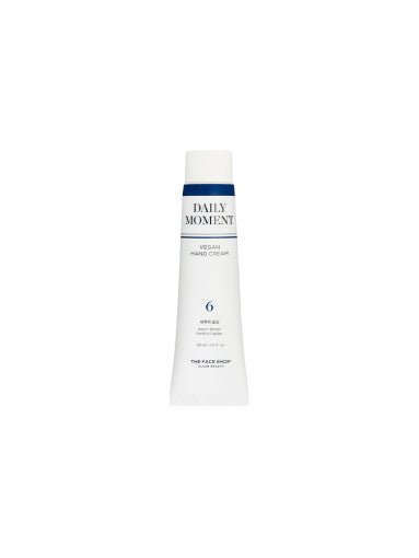 Slim white tube of vegan hand cream with navy blue accent and minimalist text on plain white background