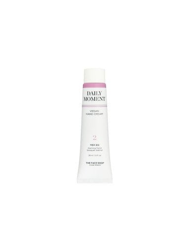 Tube of Daily Moment vegan hand cream in white and soft pink packaging labeled for long-lasting moisture benefits