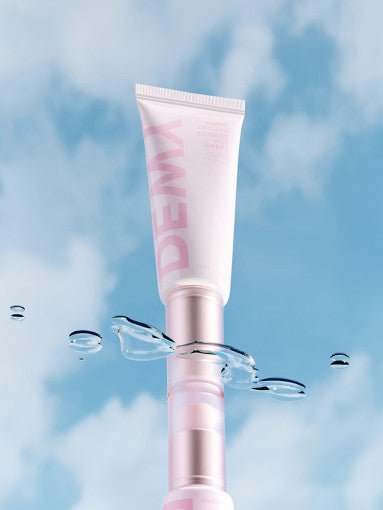 Pink tube of dewy lasting tone up sun cream with water droplets and blue sky reflection background