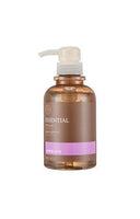 Translucent brown pump bottle of Essential Style Up hair gel with pink label band on white background
