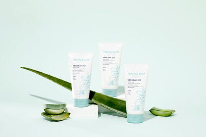 Three pastel blue tubes of gentle foaming cleanser arranged with aloe leaves and slices on pale background