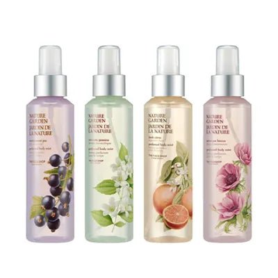 Four translucent body mist bottles with botanical illustrations, each featuring a lightweight formula and floral or fruit accents