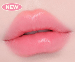 Close-up of lips wearing soft pink sheer glow lipstick with a smooth, semi-gloss finish on light background