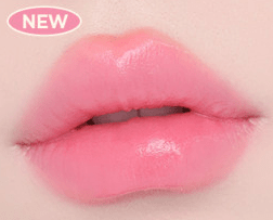 Close-up of lips wearing soft pink semi-gloss lipstick with smooth, sheer glow finish