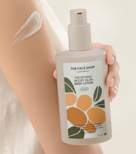 Hand holding body lotion bottle with floral label alongside smooth white lotion applied on arm skin