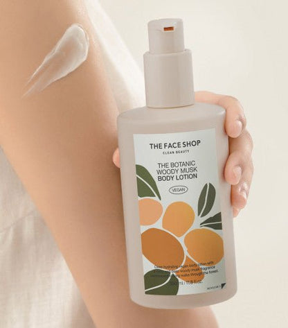 Hand holding body lotion bottle with floral label alongside smooth white lotion applied on arm skin