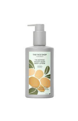 Gray pump bottle of body lotion featuring a botanical label with green leaves and orange fruit illustration