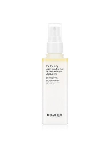 Tall white spray bottle of vegan blending mist with minimal black text on plain white background