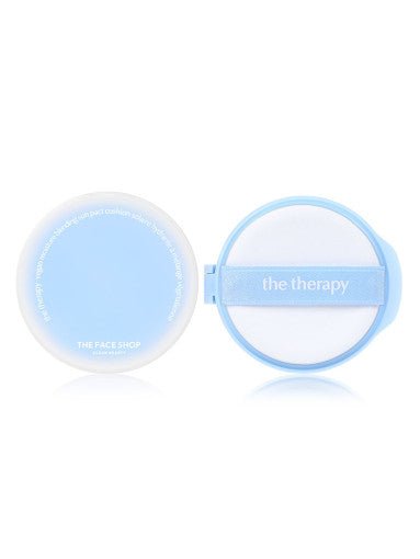 Blue compact case of moisturizing sun pact with white applicator puff featuring "the therapy" label on white background