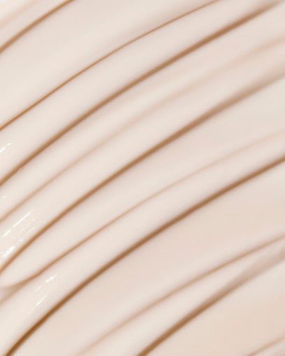 Close-up of smooth beige cream texture illustrating firming peptide anti-wrinkle skincare formula