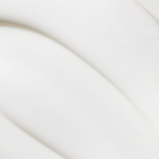 Smooth white cream texture with soft, radiant finish suggesting nourishing and anti-aging skincare benefits