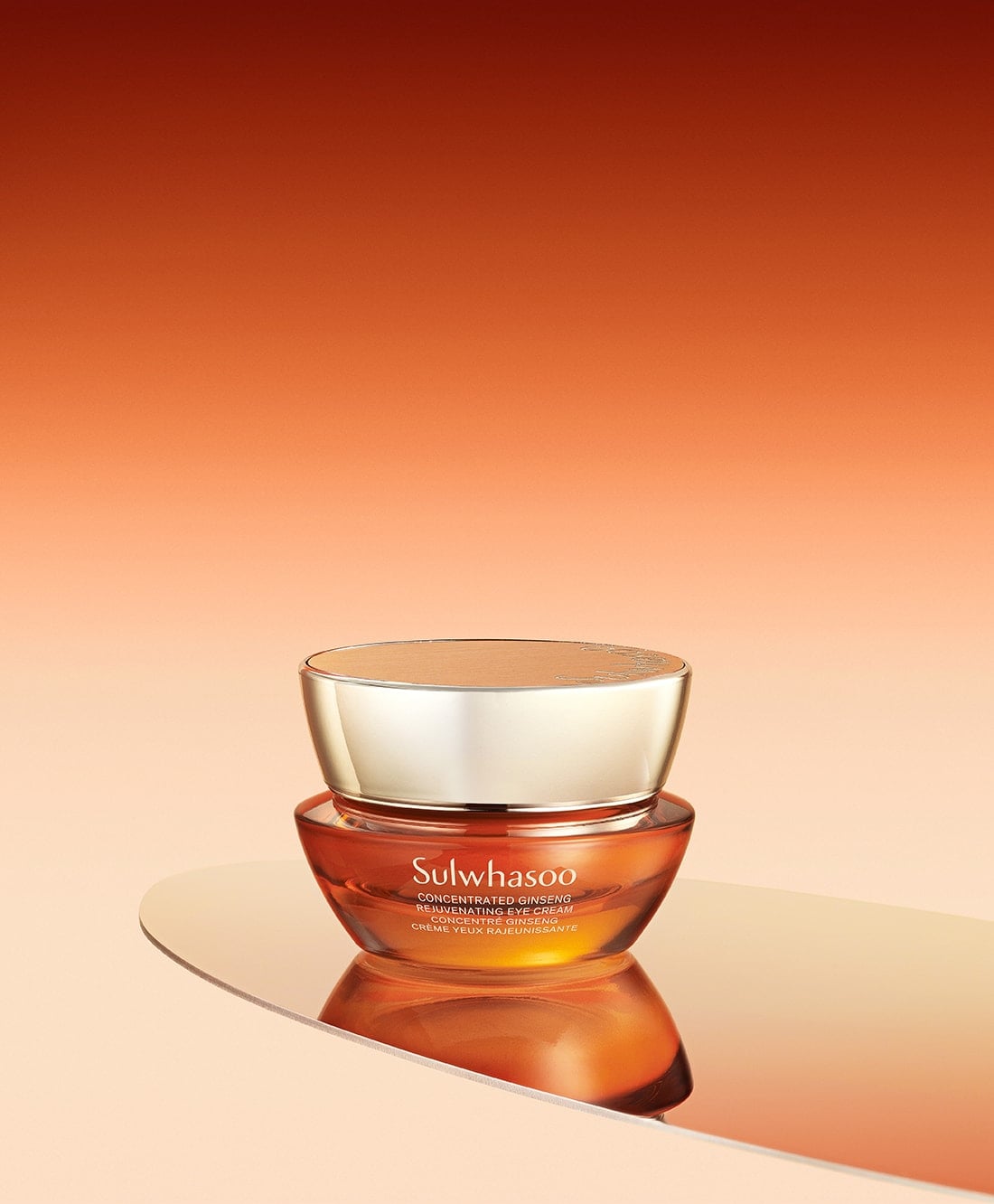 Amber and gold jar of rejuvenating eye cream with smooth, reflective surface and warm gradient background